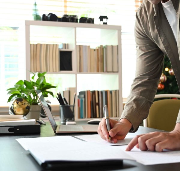 cropped-shot-young-man-standing-in-home-office