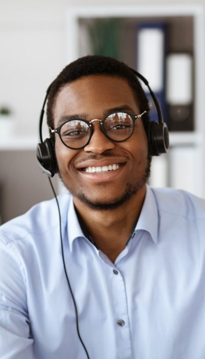 happy-black-consultant-with-headset-waving-at-camera.jpg